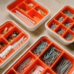 Screws and anchors sorted in orange boxes